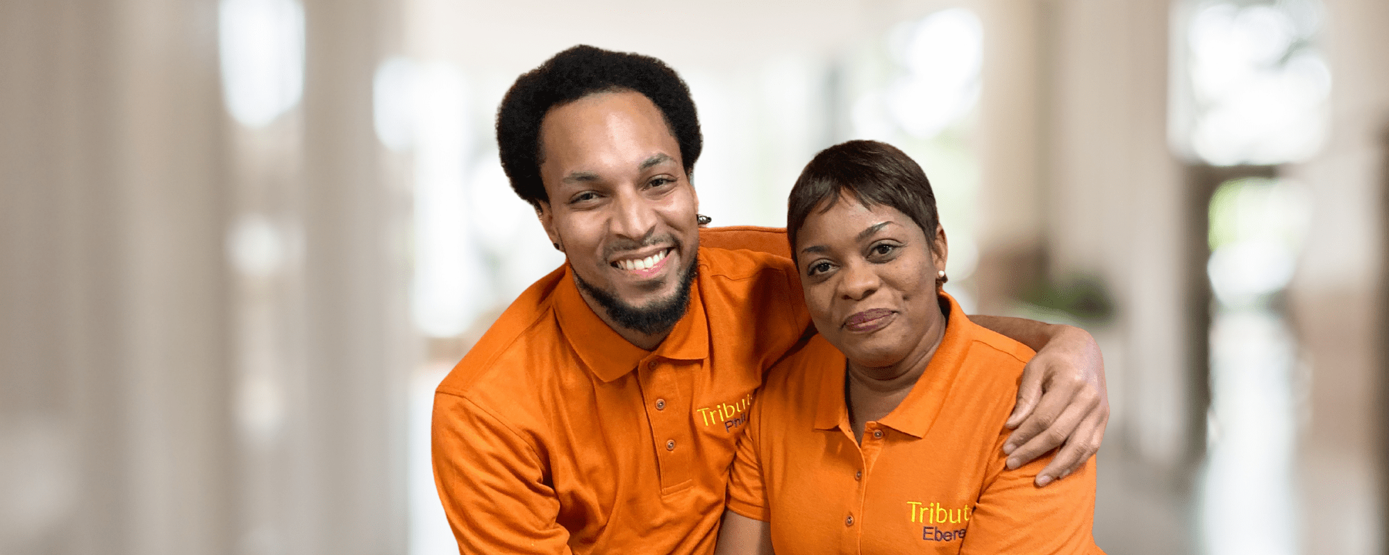 Tribute Caregivers Phil and Ebere smile together