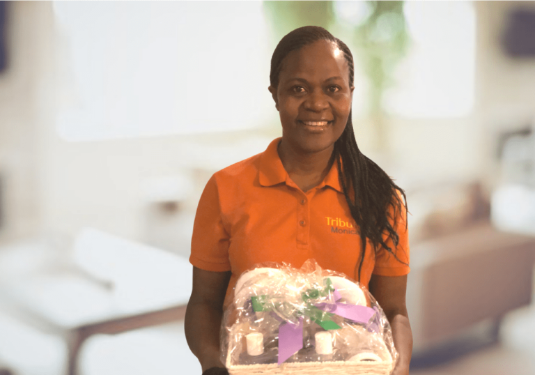 Tribute Caregiver Monica celebrates with flowers from Tribute Home Care