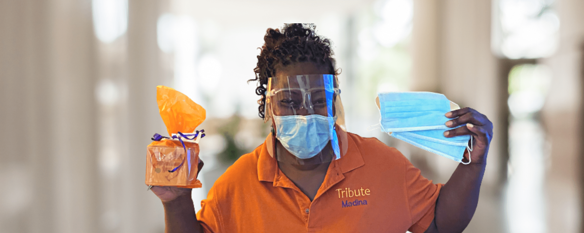 Tribute Caregiver Madina smiling with Covid mask and full PPE