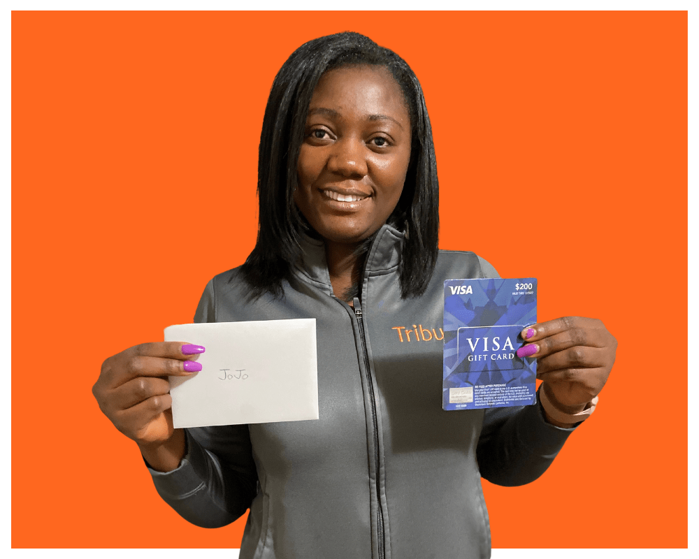 Tribute Caregiver JoJo holding up card and gift card