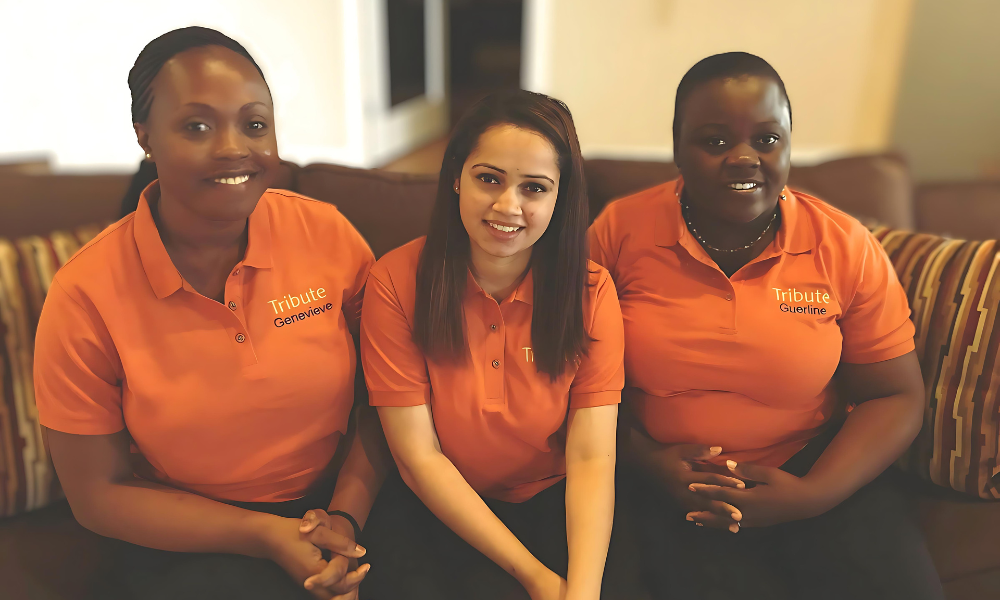 3 Tribute Caregivers smiling wearing Tribute Home Care uniforms