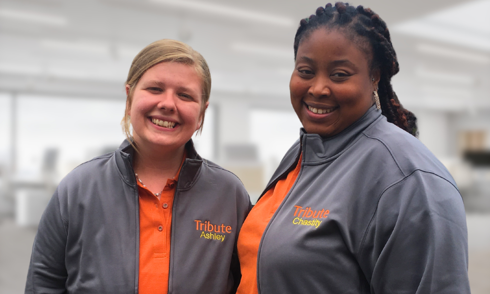 Tribute Caregivers Ashley and Chastity smiling wearing Tribute Home Care uniforms