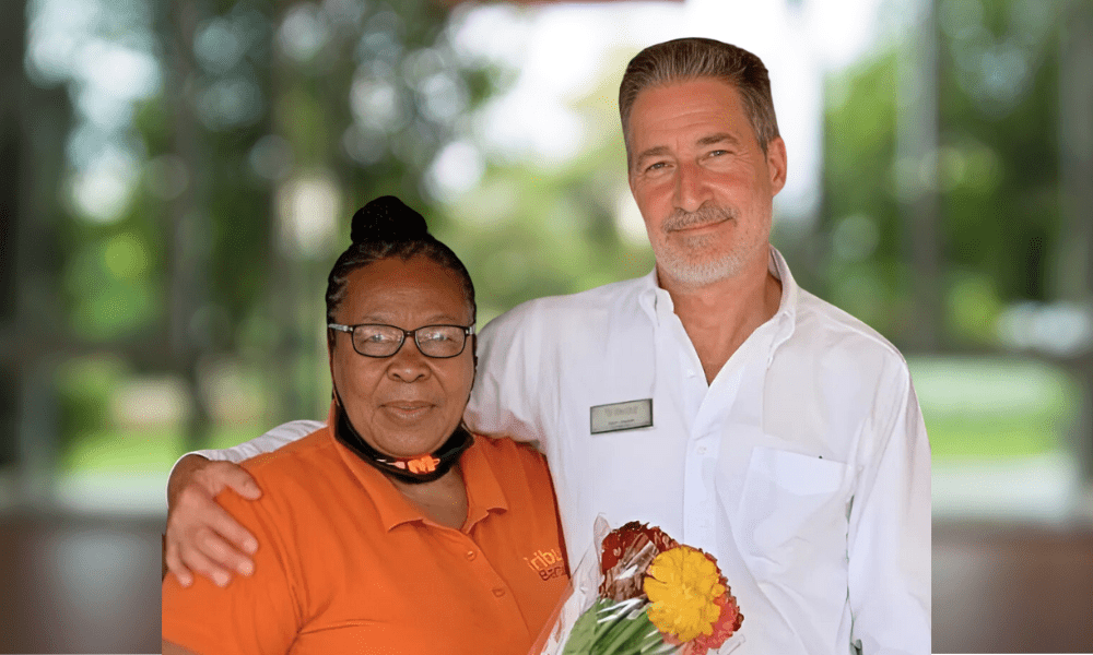 Tribute Caregiver smiling in Tribute Home Care uniform with John Sneath, Founder and CEO