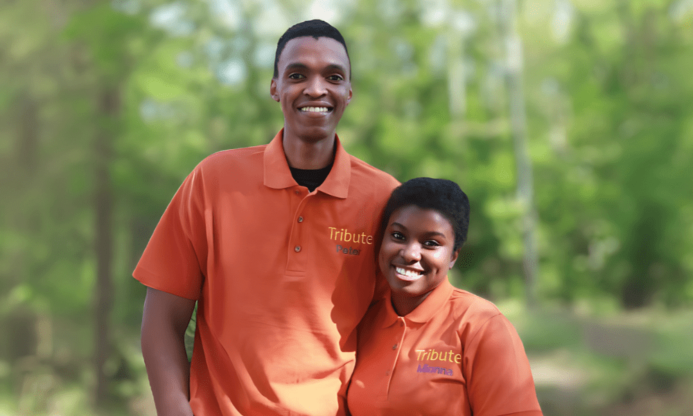 2 Tribute Caregivers smiling in Tribute Home Care uniforms