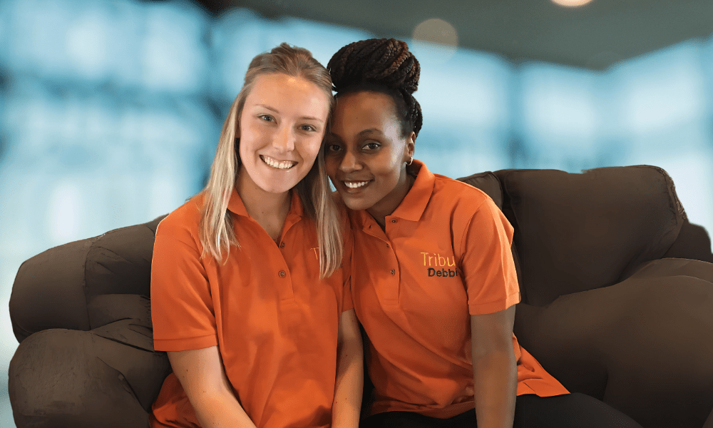 2 Tribute Caregivers smiling in Tribute Home Care uniforms