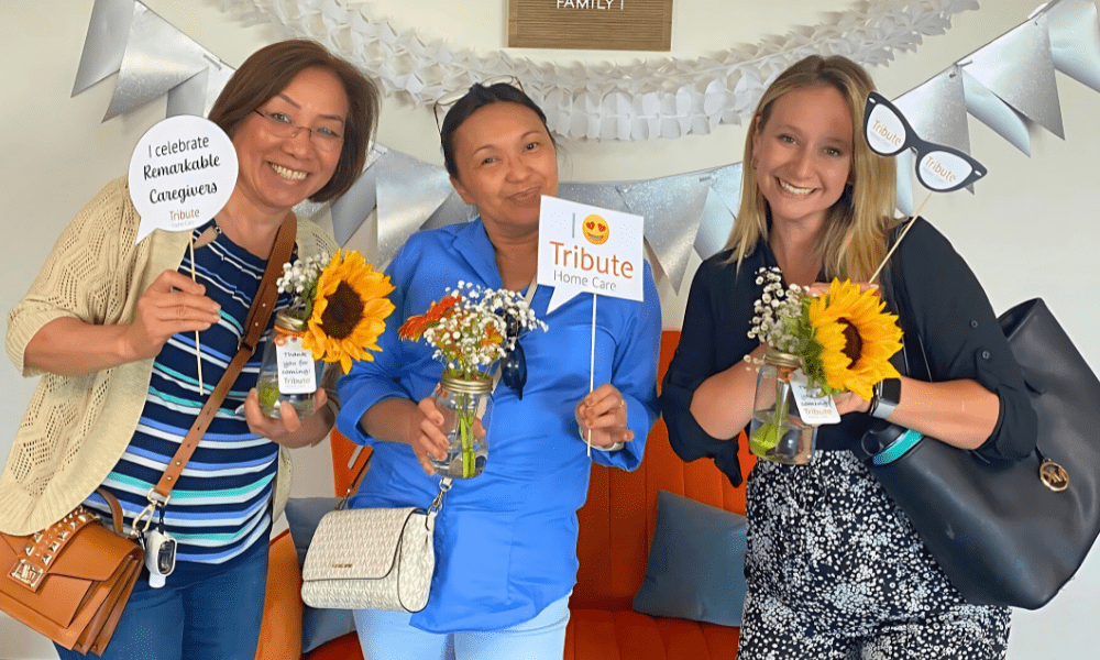 3 Tribute Chicago Caregivers smiling holding flowers