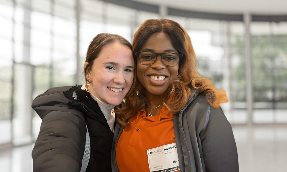 Tribute Caregiver smiling in Tribute Home Care uniform with Carrie Faerber