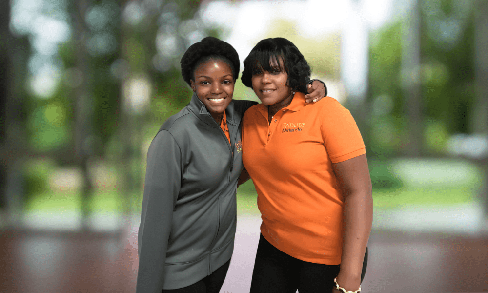 2 Tribute Caregivers smiling in Tribute Home Care uniforms