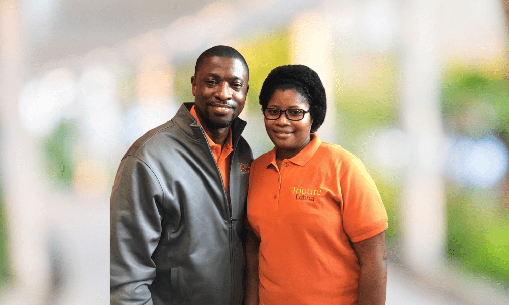 2 Tribute Caregivers smiling in Tribute Home Care uniforms