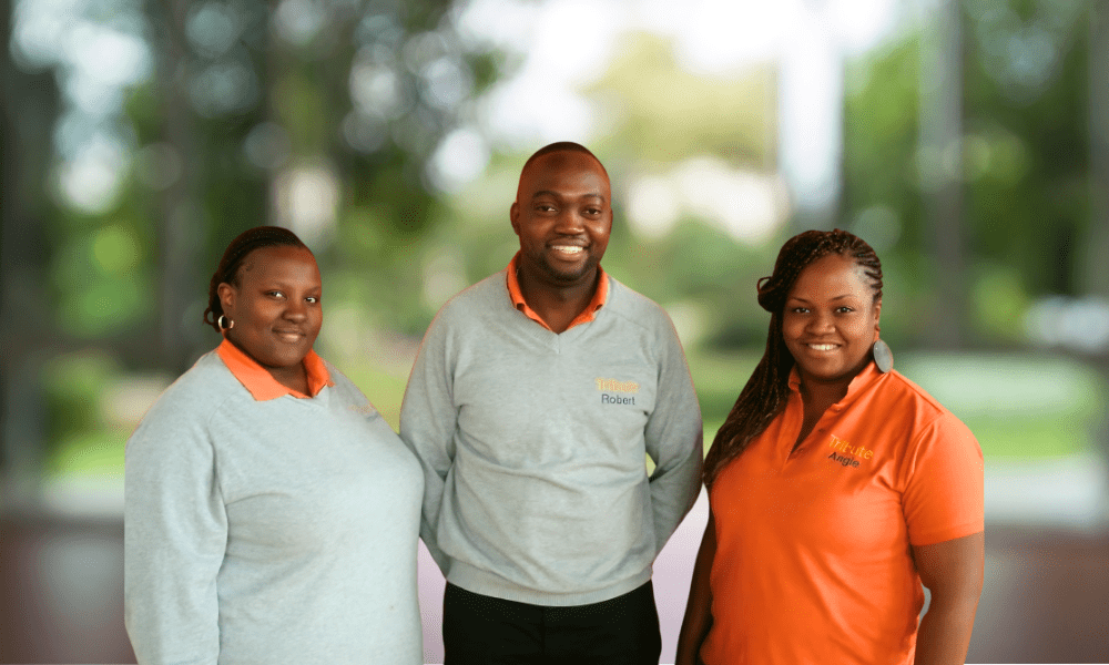 3 Tribute Caregivers smiling in Tribute Home Care uniforms