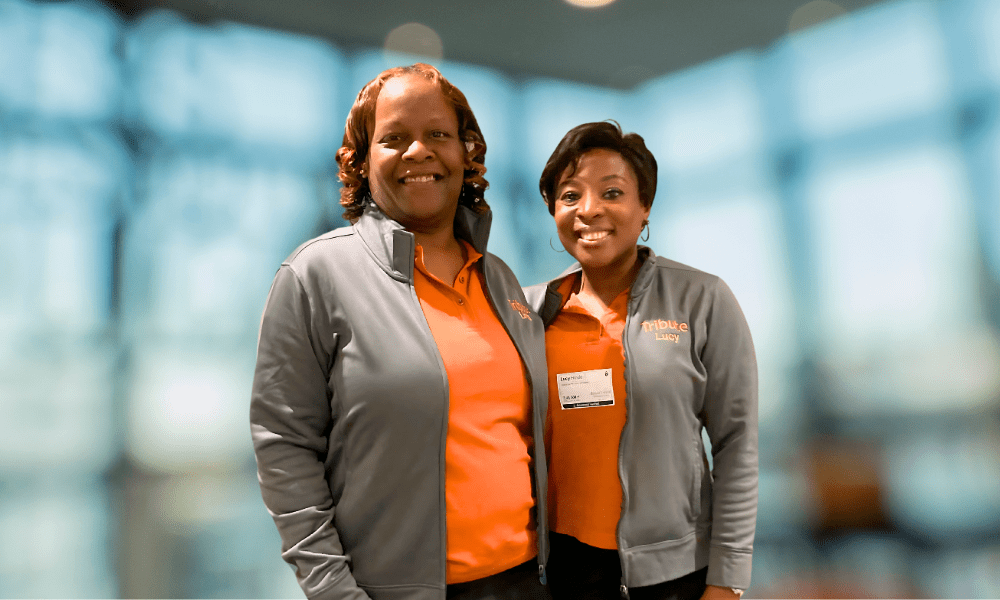 2 Tribute Caregivers smiling in Tribute Home Care uniforms