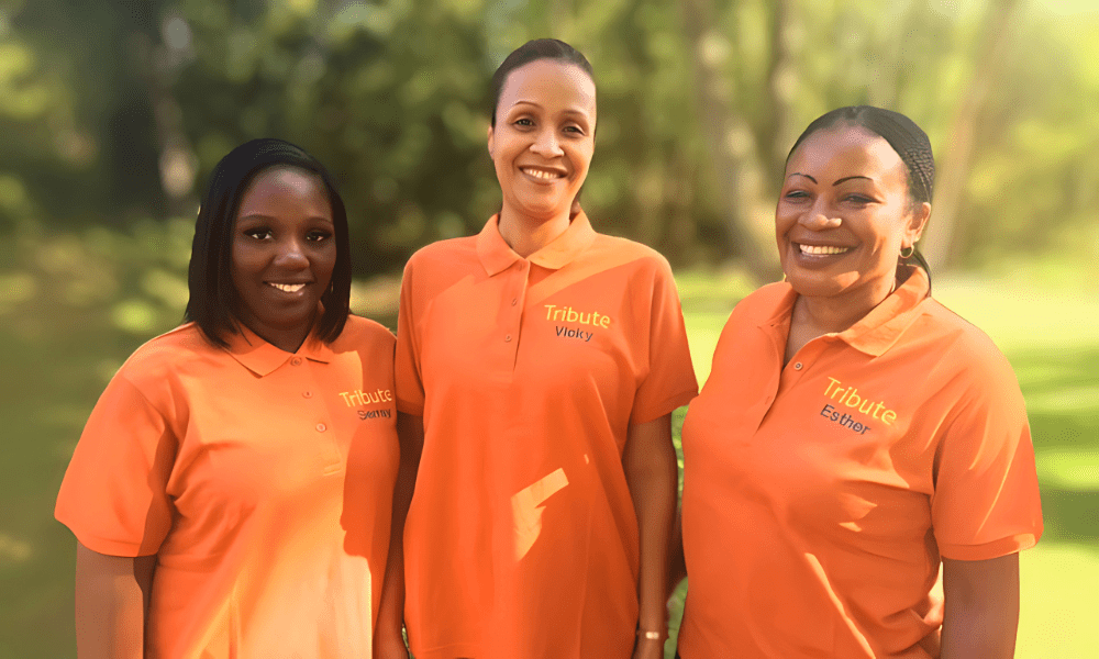 3 Tribute Caregivers smiling in Tribute Home Care uniforms