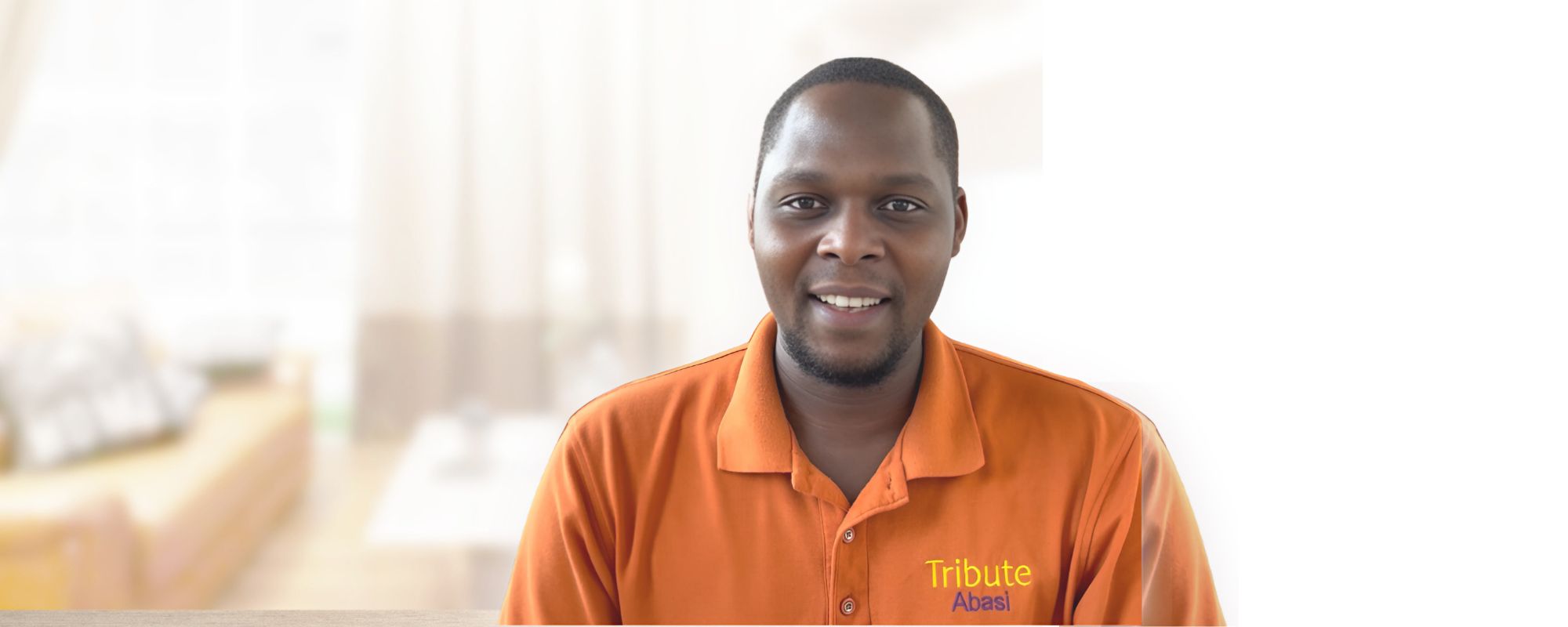 Tribute Caregiver Abasi smiling in Tribute Home Care uniform