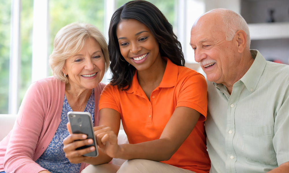 Tribute Home Care Caregiver sharing care updates on mobile app with a client and family member during a home visit